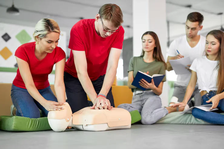 group-young-caucasian-people-learning-how-safe-life-sitting-together_183219-3277 cpr training